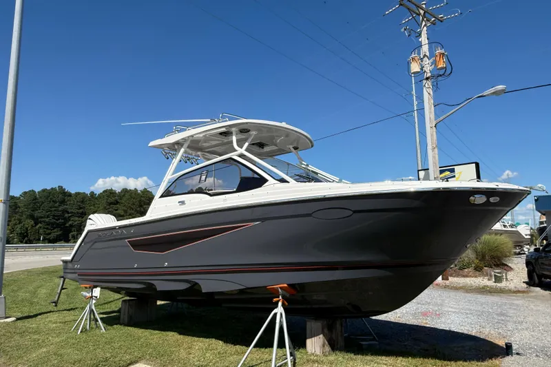 Slide: The Image of 2026 Solara S-250 DC boat displayed outdoors on a sunny day. - 2
