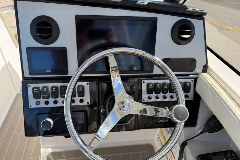 Slide: The Image of 2026 Solara S-250 DC boat dashboard with steering wheel and control panel. - 9
