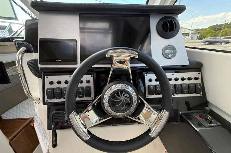 Slide: The Image of 2026 Solara S-250 C boat dashboard with modern controls and steering wheel. - 14
