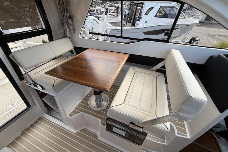 Slide: The Image of Interior of 2026 Solara S-250 C boat with elegant seating and wooden table. - 15