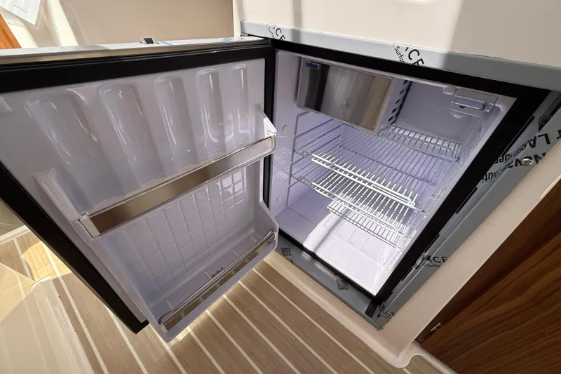 Slide: The Image of Open refrigerator in Solara S-250 C, 2026 model, showcasing interior shelves and door storage. - 16