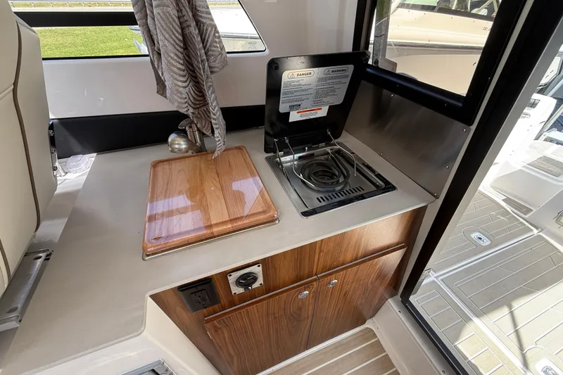 Slide: The Image of Compact kitchen area in 2026 Solara S-250 C boat with stove and cutting board. - 17