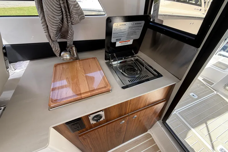 Slide: The Image of Compact kitchen area in 2026 Solara S-250 C boat with stove and cutting board. - 18