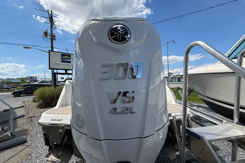 Slide: The Image of 2026 Solara S-250 C boat with 300 V6 4.2L engine at dealership. - 19