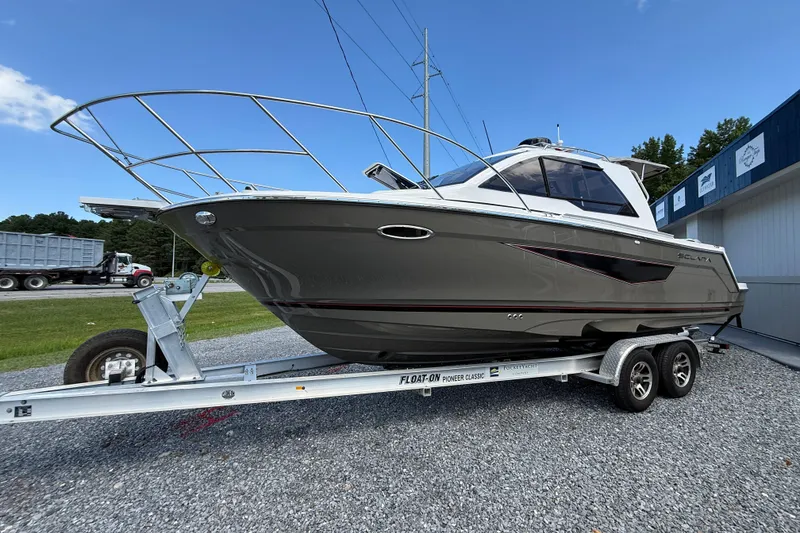 Slide: The Image of 2026 Solara S-250 C boat on trailer, parked outdoors, showcasing sleek design and modern features. - 3
