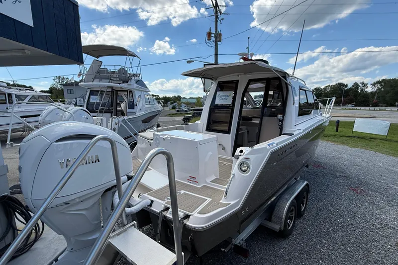Slide: The Image of 2026 Solara S-250 C boat with Yamaha engine on display at a marina. - 5