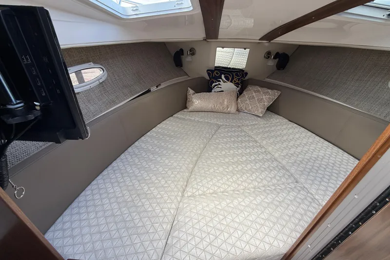 Slide: The Image of Cozy cabin interior of 2026 Solara S-250 C boat with comfortable bedding. - 9