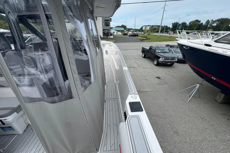 Slide: The Image of 2026 Solara S-310 CW boat docked, showcasing sleek design and modern features. - 11