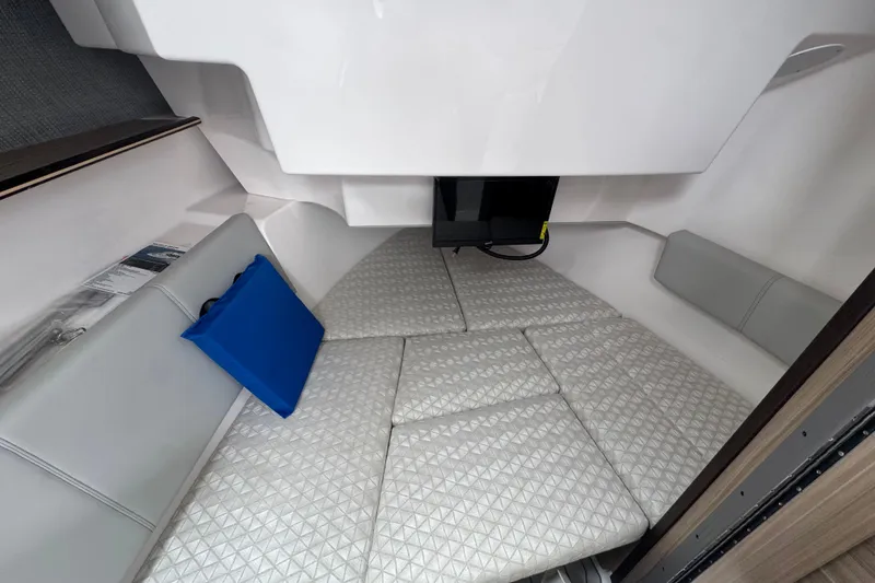 Slide: The Image of Interior cabin of 2026 Solara S-310 CW boat with cushioned seating and blue pillow. - 14