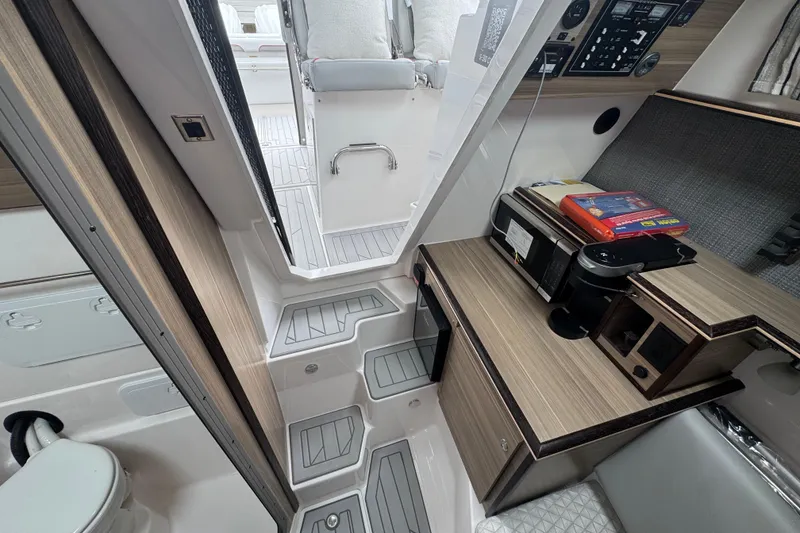 Slide: The Image of Interior of 2026 Solara S-310 CW boat with modern kitchenette and seating area. - 16
