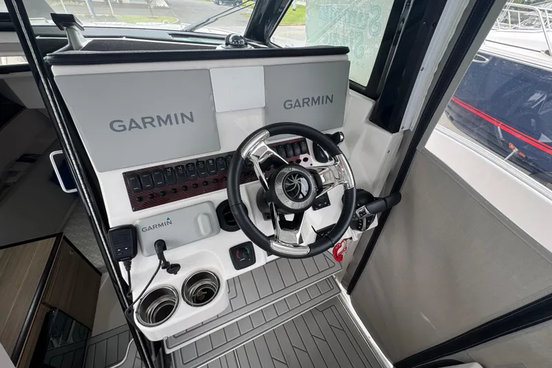 Slide: The Image of 2026 Solara S-310 CW boat cockpit with Garmin navigation system and modern steering wheel. - 17