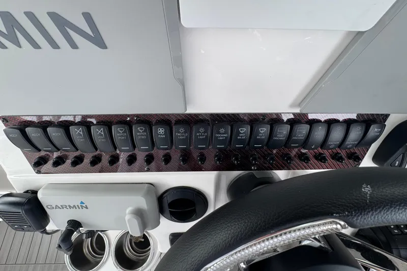 Slide: The Image of Control panel of 2026 Solara S-310 CW boat with various switches and Garmin device. - 18