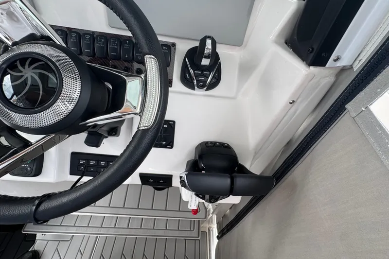 Slide: The Image of Steering wheel and controls of 2026 Solara S-310 CW boat cockpit. - 19