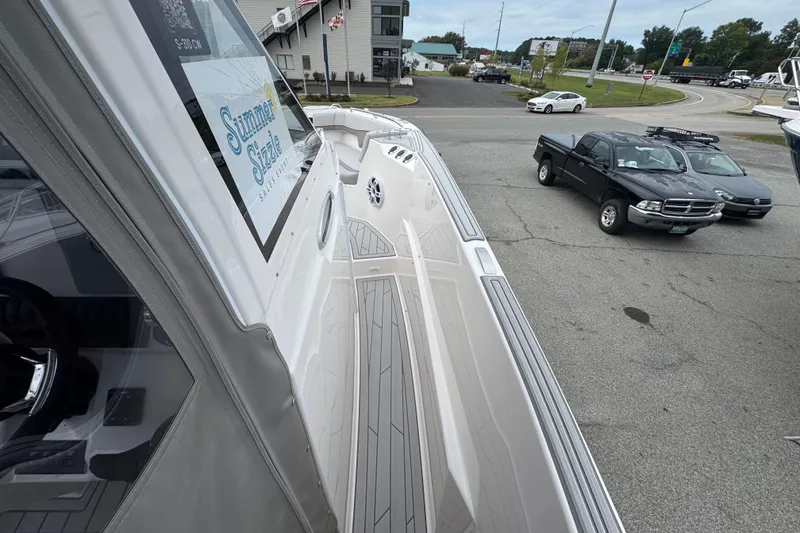 Slide: The Image of 2026 Solara S-310 CW boat on display at a dealership parking lot. - 24