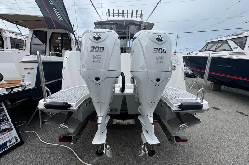 Slide: The Image of 2026 Solara S-310 CW boat with dual 300 V6 outboard engines displayed at a marina. - 6
