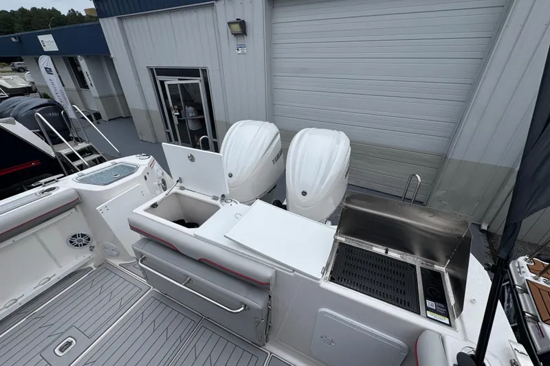 Slide: The Image of 2026 Solara S-310 CW boat with dual engines and outdoor grill setup. - 9