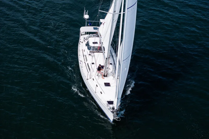 Slide: The Image of Aerial view of 2024 Outbound 46 sailboat navigating through deep blue waters. - 2