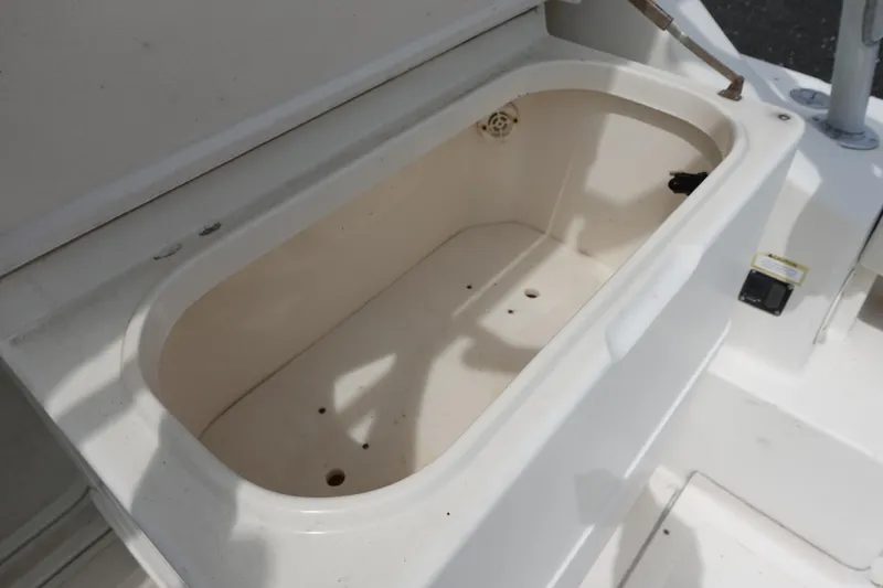 Slide: The Image of Open storage compartment on a 1997 Pursuit 3400 Offshore boat. - 16
