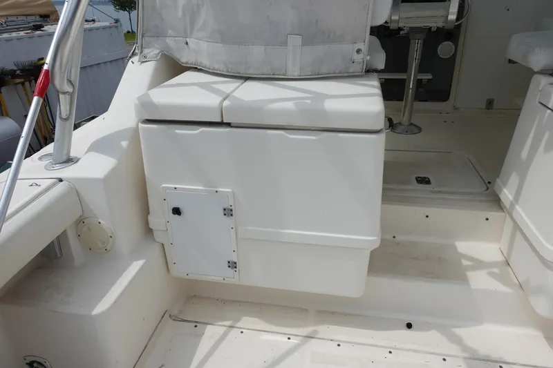 Slide: The Image of 1997 Pursuit 3400 Offshore boat interior with storage compartment and seating area. - 17