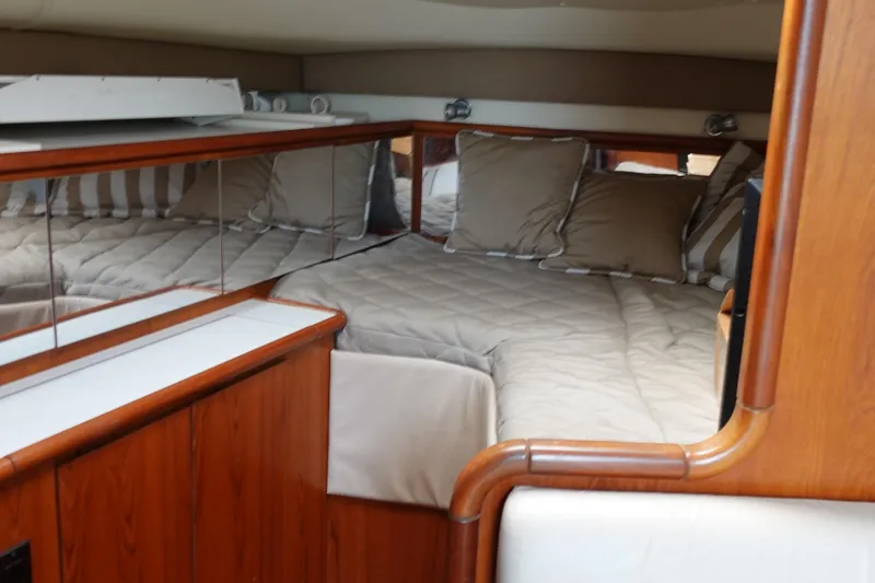 Slide: The Image of Luxurious cabin interior of a 1997 Pursuit 3400 Offshore boat with cozy bedding. - 27