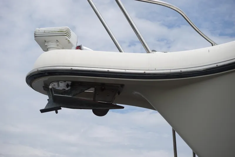 Slide: The Image of Bow of 1997 Pursuit 3400 Offshore boat with anchor and railing against cloudy sky. - 3