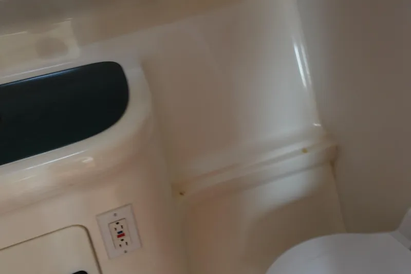 Slide: The Image of 1997 Pursuit 3400 Offshore interior detail with electrical outlet and seating. - 32