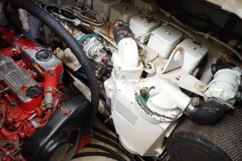 Slide: The Image of Engine compartment of a 1997 Pursuit 3400 Offshore boat, showing mechanical components. - 34
