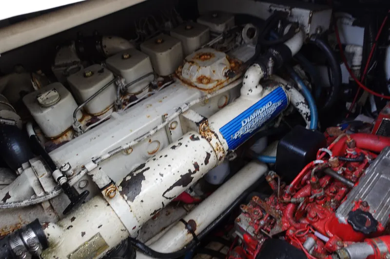 Slide: The Image of Engine compartment of a 1997 Pursuit 3400 Offshore boat, showing mechanical components. - 35