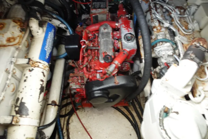 Slide: The Image of Engine compartment of a 1997 Pursuit 3400 Offshore boat, showing mechanical components. - 36