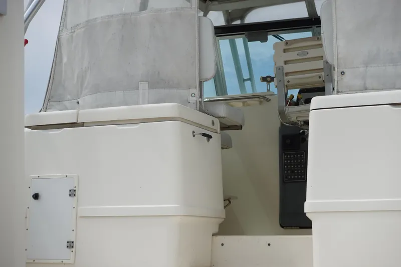 Slide: The Image of 1997 Pursuit 3400 Offshore boat cockpit with seating and control panel. - 7