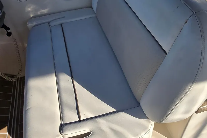 Slide: The Image of 2007 Rinker 320 Express Cruiser interior seating, featuring light-colored upholstery. - 17