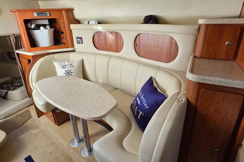 Slide: The Image of 2007 Rinker 320 Express Cruiser interior with cozy seating and table. - 29
