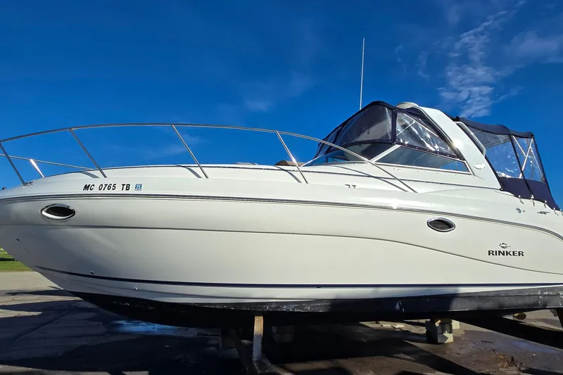 Slide: The Image of 2007 Rinker 320 Express Cruiser boat on display under clear blue sky. - 3