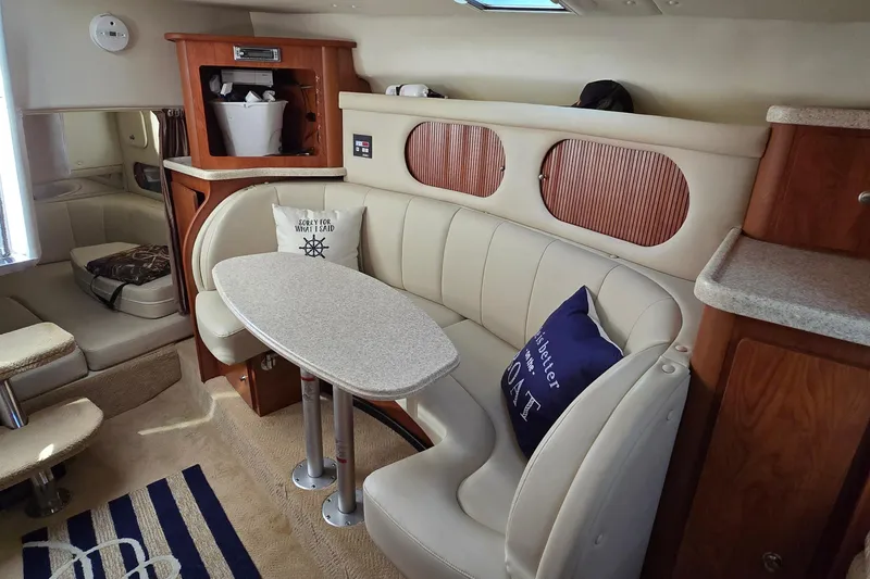 Slide: The Image of 2007 Rinker 320 Express Cruiser interior with cozy seating and table setup. - 30