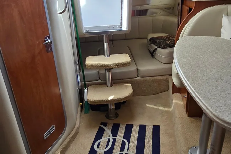 Slide: The Image of 2007 Rinker 320 Express Cruiser interior with steps, seating, and table. - 31