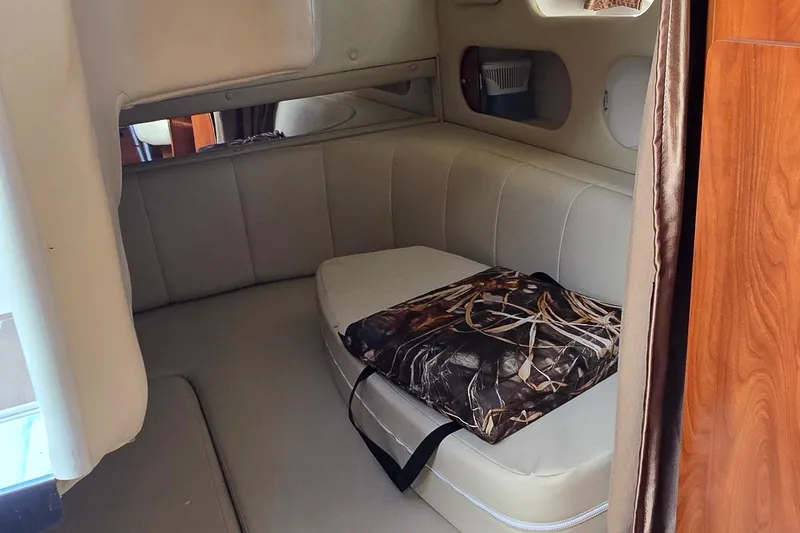 Slide: The Image of Interior cabin of 2007 Rinker 320 Express Cruiser with beige seating. - 32