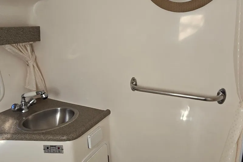 Slide: The Image of 2007 Rinker 320 Express Cruiser bathroom with sink and grab bar. - 36