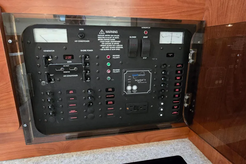 Slide: The Image of Electrical control panel of a 2007 Rinker 320 Express Cruiser boat. - 38