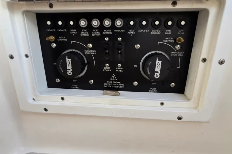 Slide: The Image of Control panel of a 2007 Rinker 320 Express Cruiser boat with various switches and dials. - 39