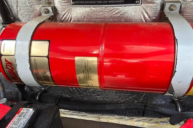 Slide: The Image of Red fire extinguisher in a 2007 Rinker 320 Express Cruiser engine compartment. - 40
