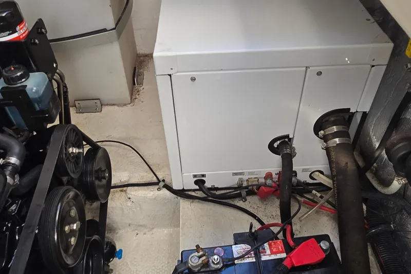 Slide: The Image of Engine compartment of a 2007 Rinker 320 Express Cruiser with visible components and wiring. - 41