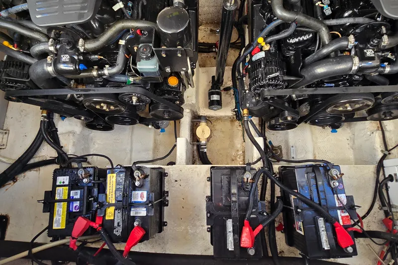 Slide: The Image of Engine compartment of a 2007 Rinker 320 Express Cruiser with visible batteries and components. - 45