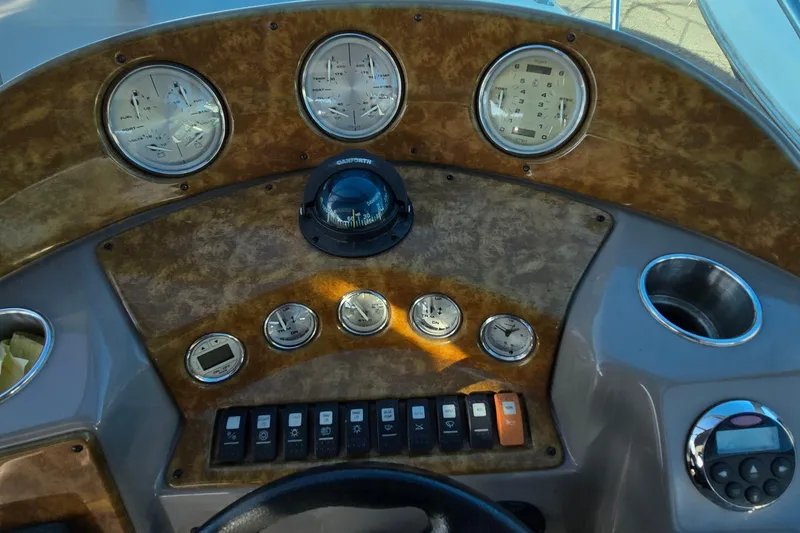 Slide: The Image of Dashboard of a 2007 Rinker 320 Express Cruiser with gauges and controls. - 8