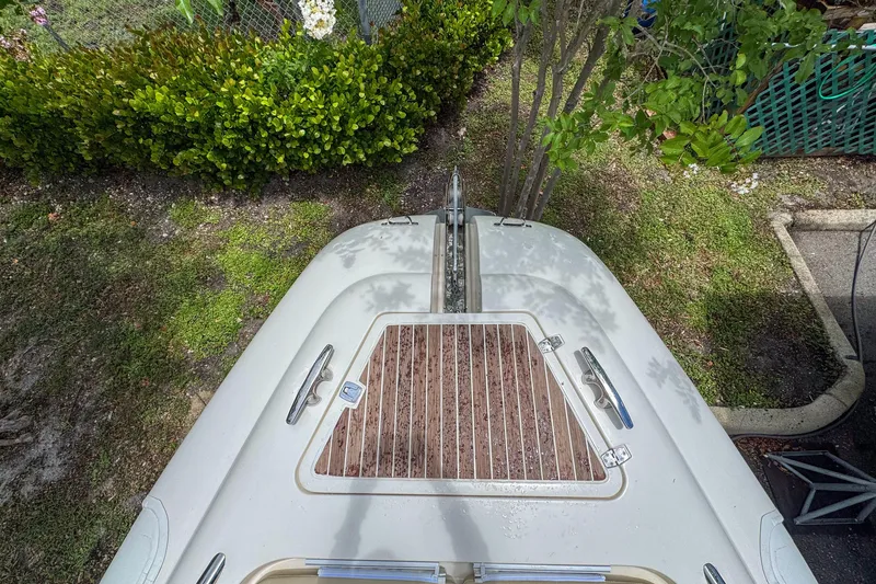 Slide: The Image of Top view of 2023 Tender Impertus 36 boat with wooden deck, surrounded by greenery. - 12