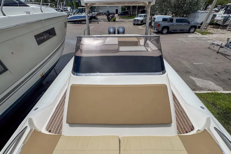 Slide: The Image of 2023 Tender Impertus 36 boat with spacious deck and sleek design in a marina setting. - 13