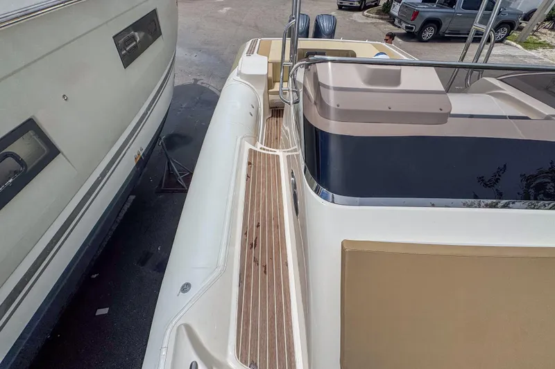 Slide: The Image of 2023 Tender Impertus 36 boat docked beside another vessel, showcasing sleek design. - 15