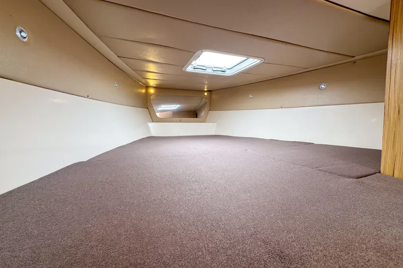 Slide: The Image of Interior cabin of 2023 Tender Impertus 36 with skylight and brown carpeting. - 22