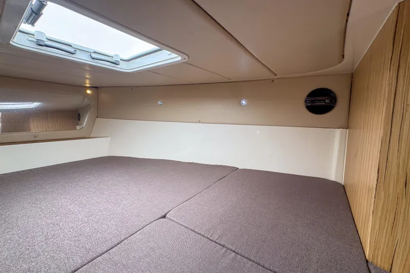 Slide: The Image of Cozy interior cabin of 2023 Tender Impertus 36 with skylight and wood accents. - 23
