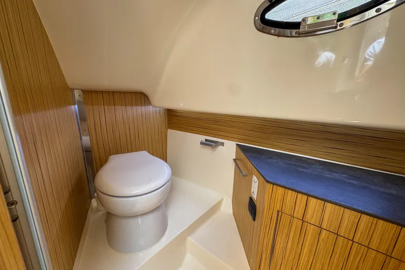 Slide: The Image of Modern bathroom interior of 2023 Tender Impertus 36 boat with wood accents and porthole. - 26