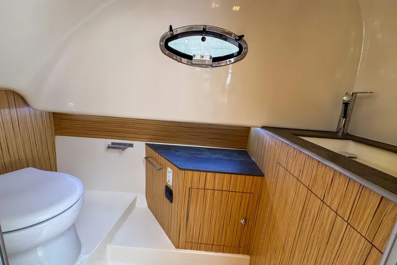 Slide: The Image of Modern bathroom interior of 2023 Tender Impertus 36 yacht with wood accents and porthole. - 27